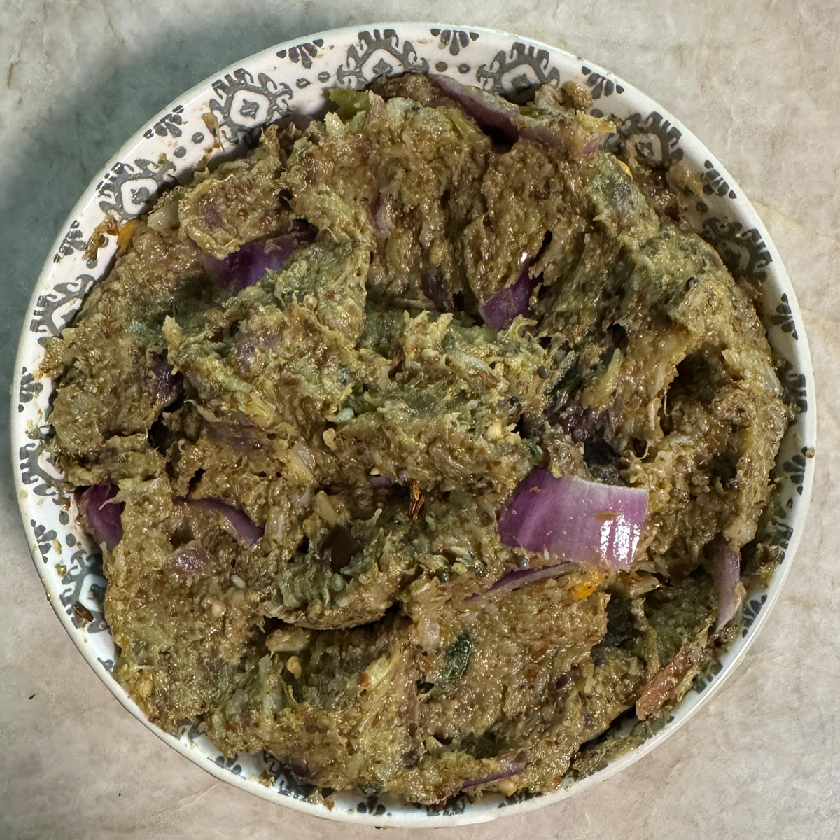 Freshly prepared broccoli eggplant chutney served in a traditional bowl ready to enjoy