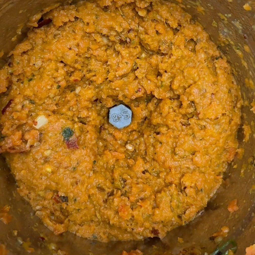 Smooth and creamy carrot chutney served in a bowl after blending
