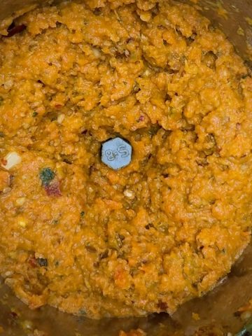 Smooth and creamy carrot chutney served in a bowl after blending