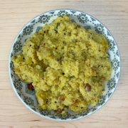 Fluffy South Indian upma served in a bowl, made with semolina (rava), vegetables, and aromatic spices, ready to eat on a wooden table.