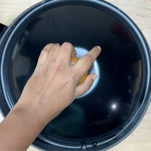 Lid covering the pan to steam and soften carrots for the chutney