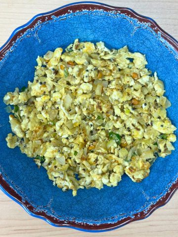 Finished egg bhurji served in a bowl on a wooden table