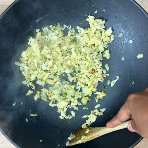 Stirring and scrambling the eggs in a pan