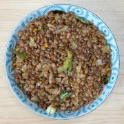 Homemade tempered horsegram snack served in a rustic bowl, featuring protein-rich ulavalu with aromatic Indian spices.