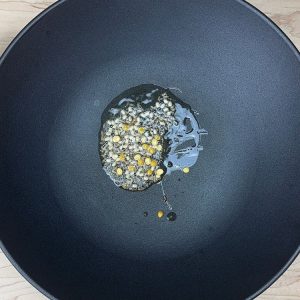 Whole spices tempering in hot oil in a frying pan
