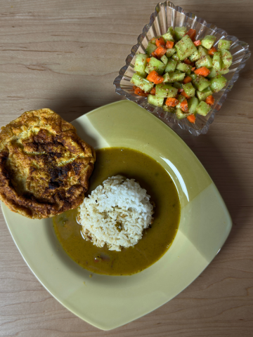 Balanced Thali with white rice, flavorful Ulavacharu Rasam, protein-rich omelet, & crisp salad on a plate.