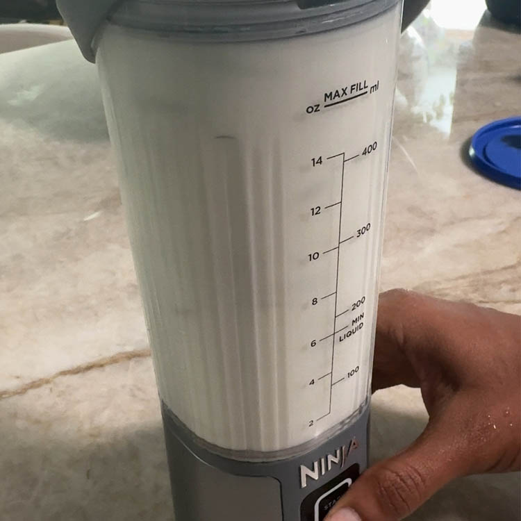 Blending all ingredients – water, green chili, ginger, coriander, salt, lime juice, and yogurt – for smooth and frothy homemade buttermilk.
