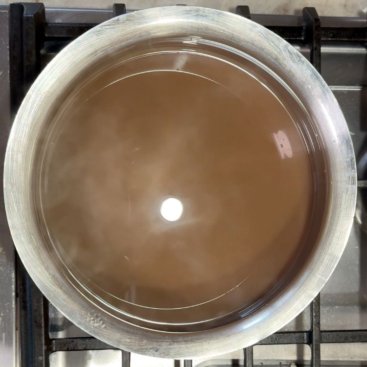 Horsegram water boiling in a pot on stovetop