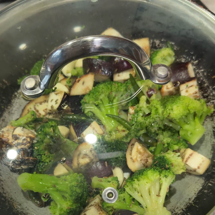 Cooking broccoli eggplant chutney with covered lid to properly soften vegetables