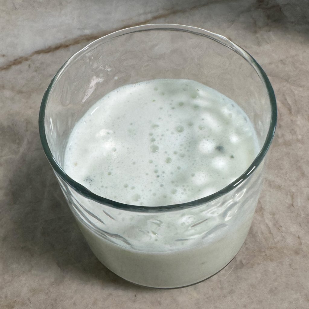 A glass of chilled homemade buttermilk, garnished with optional roasted cumin powder, ready to enjoy as a refreshing and healthy drink.