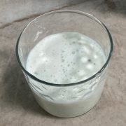 A glass of chilled homemade buttermilk, garnished with optional roasted cumin powder, ready to enjoy as a refreshing and healthy drink.