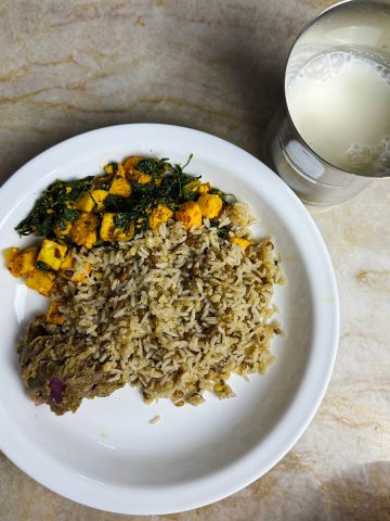 Nutritious Indian thali featuring high-protein rice, creamy methi paneer, vibrant broccoli eggplant chutney, and a refreshing glass of homemade buttermilk. Perfect for a healthy, balanced meal.