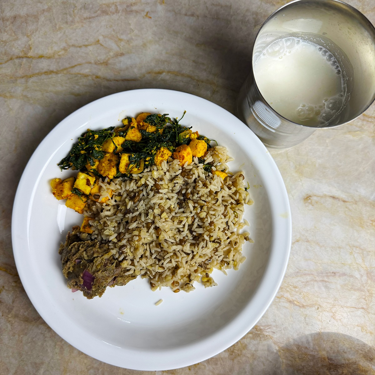 Nutritious Indian thali featuring high-protein rice, creamy methi paneer, vibrant broccoli eggplant chutney, and a refreshing glass of homemade buttermilk. Perfect for a healthy, balanced meal.