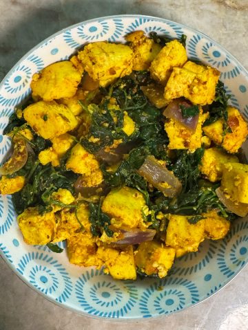 A serving of hot Methi Paneer Stir Fry in a bowl, garnished and ready to be enjoyed, showcasing the finished dish.