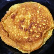 Freshly made chili egg omelette served on a plate, golden brown and ready to eat