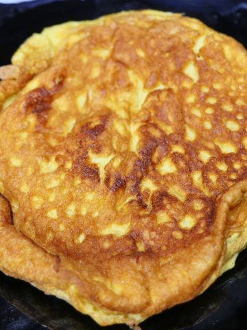 Freshly made chili egg omelette served on a plate, golden brown and ready to eat