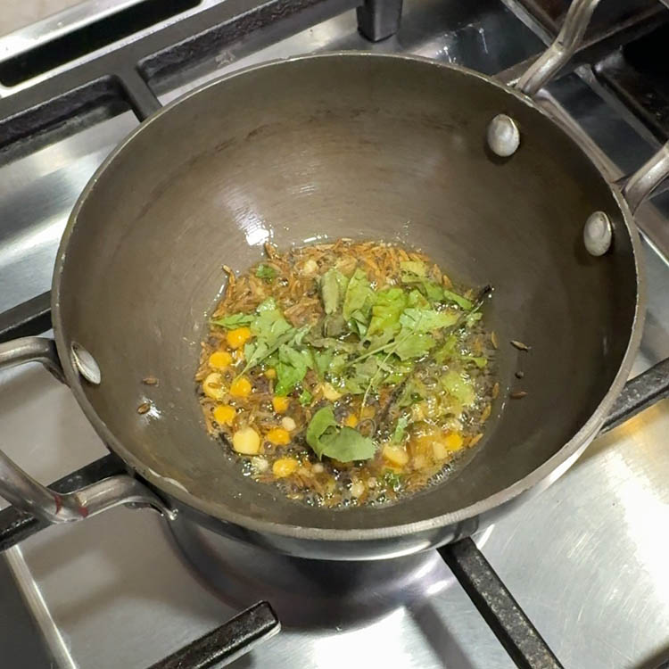 Tempering aromatic spices to enhance flavor of homemade broccoli eggplant chutney