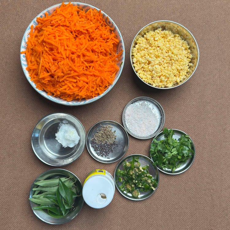 Fresh ingredients for carrot moong dal kosambari including grated carrots, yellow moong dal, and aromatic spices