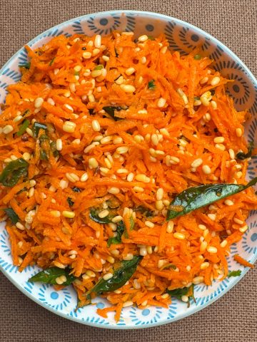 Vibrant South Indian carrot moong dal kosambari garnished with fresh coriander in a traditional serving bowl