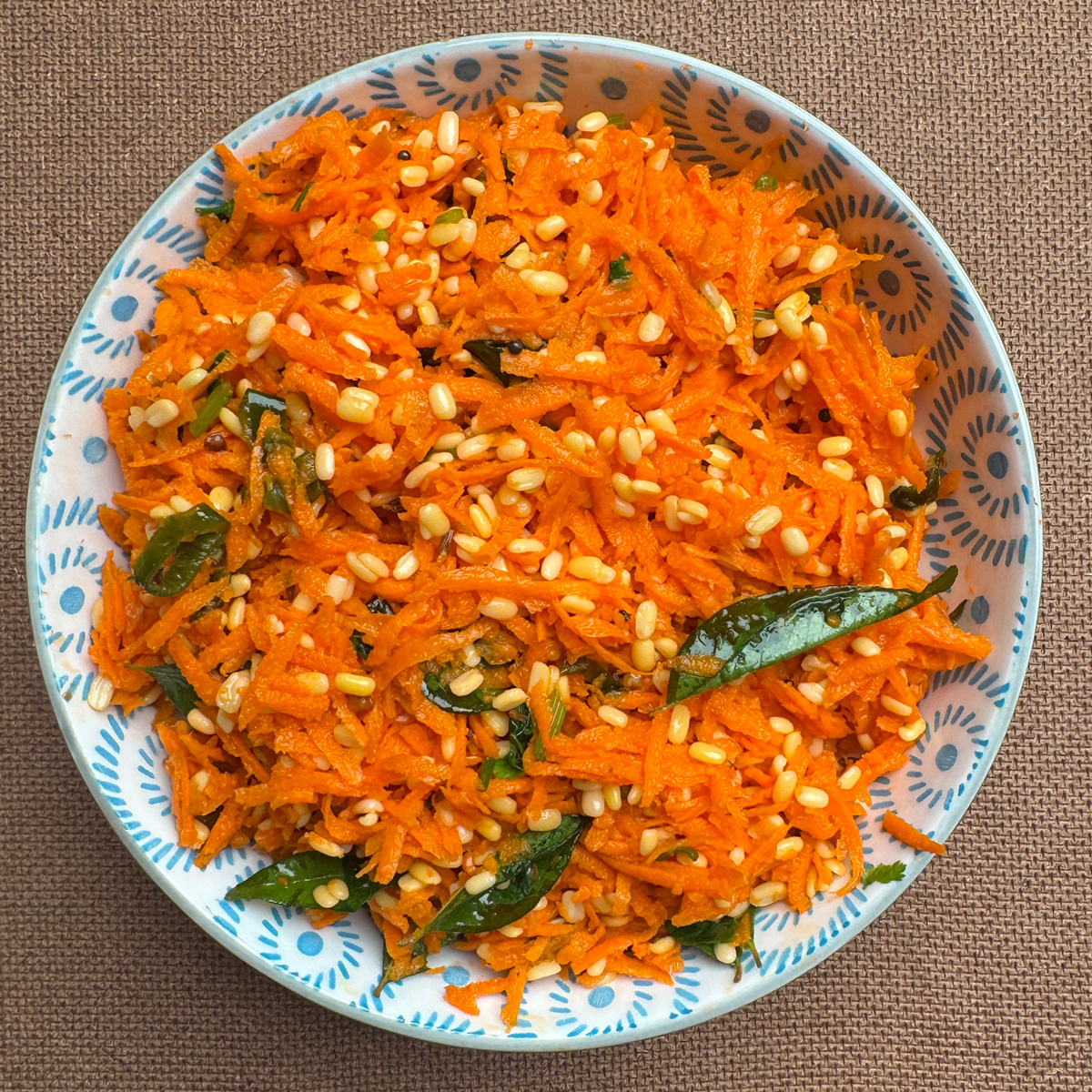 Vibrant South Indian carrot moong dal kosambari garnished with fresh coriander in a traditional serving bowl