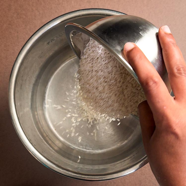 Pouring one cup of white rice into empty Instant Pot liner