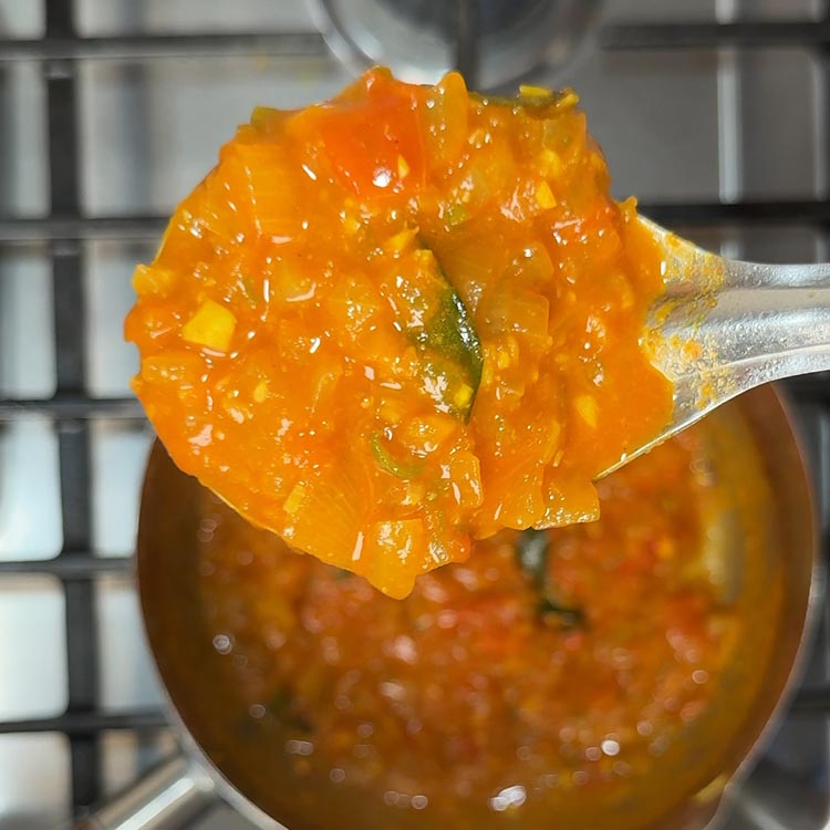 Thick, reddish-brown curry base with proper consistency before adding eggs