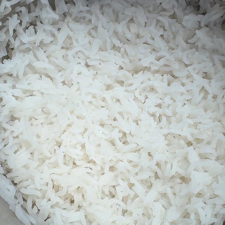 Close-up of fluffy white rice grains with steam rising