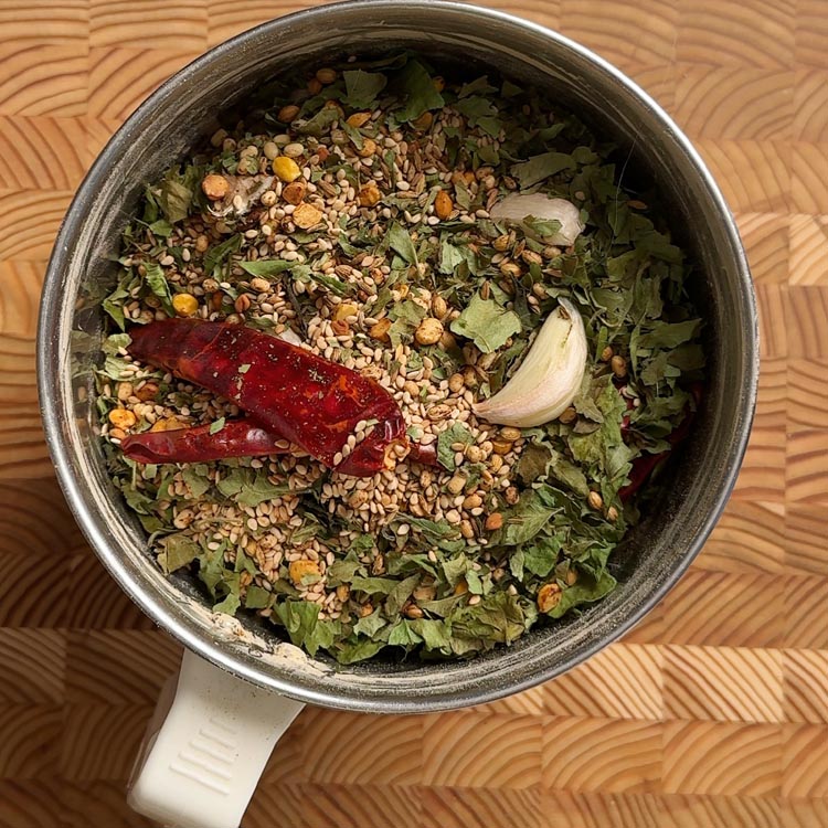 Coarse spice mixture being ground in traditional Indian mixi grinder