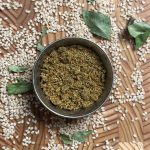 Fragrant sesame curry leaves powder served in traditional steel bowl ready to eat