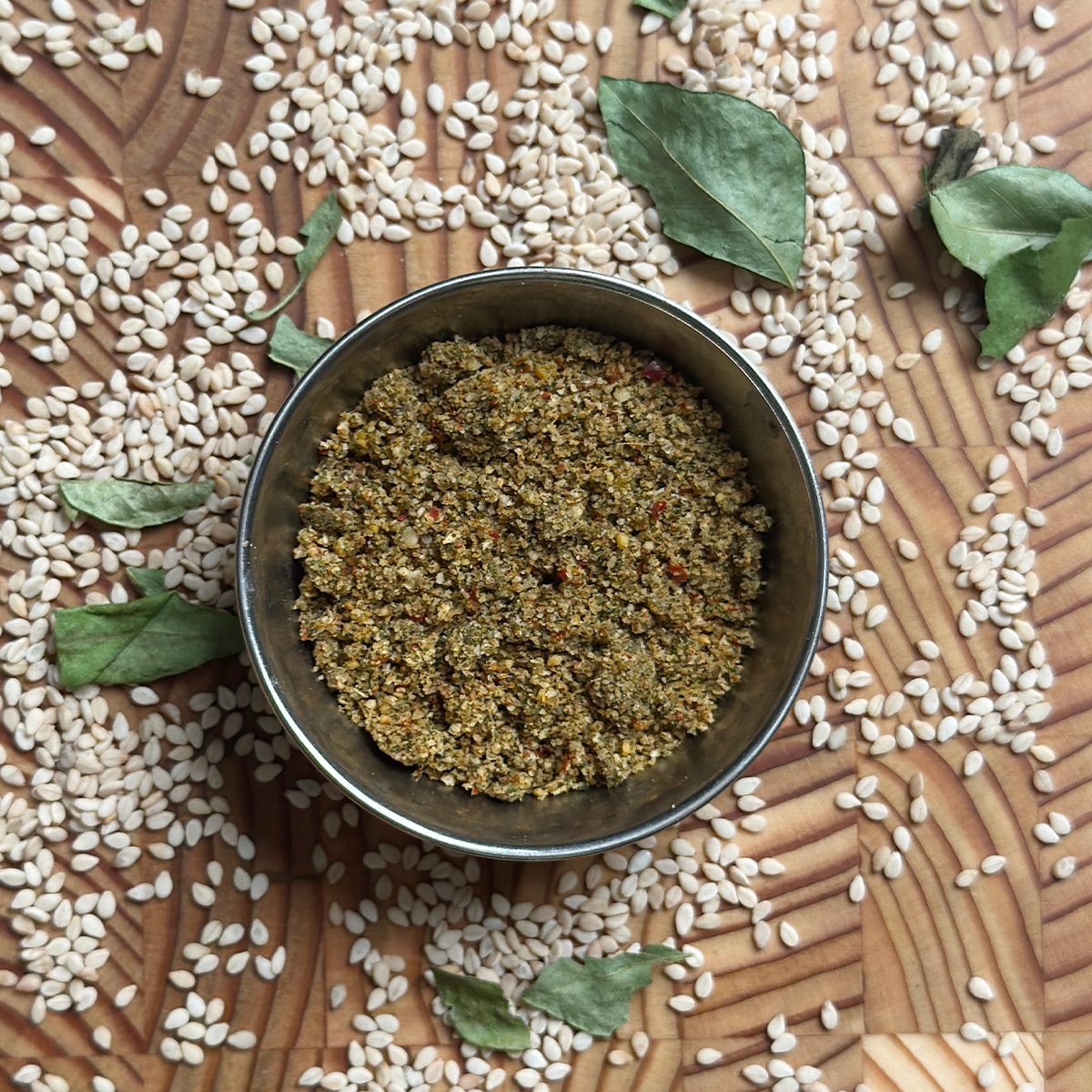 Fragrant sesame curry leaves powder served in traditional brass bowl ready to eat