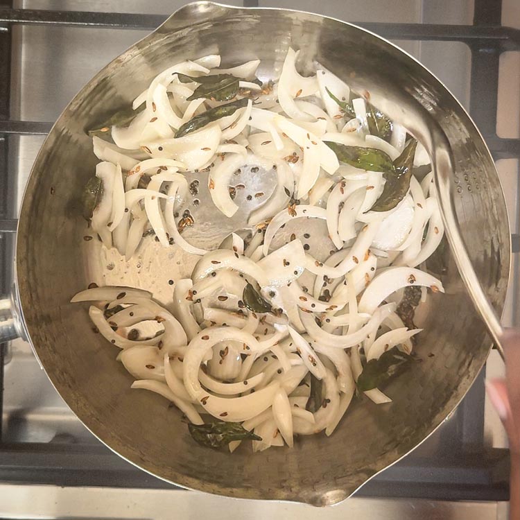 Diced onions turning golden brown in tempered oil