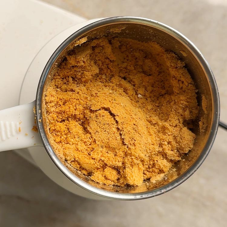 Freshly ground Senaga Pappu Podi showing coarse, aromatic powder texture with visible spice flecks