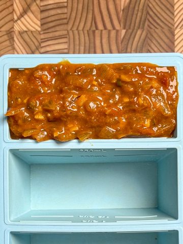 tamarind onion tomato base in a freezing tray showing one cup filled