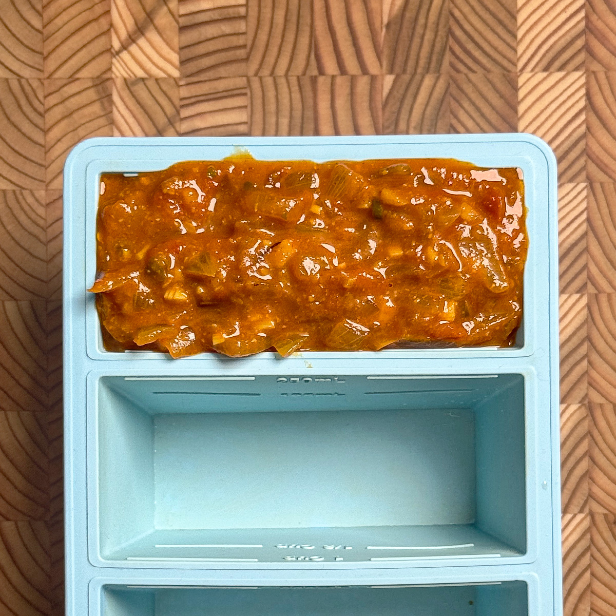 Tamarind onion tomato curry base in a stainless steel pan showing perfect consistency