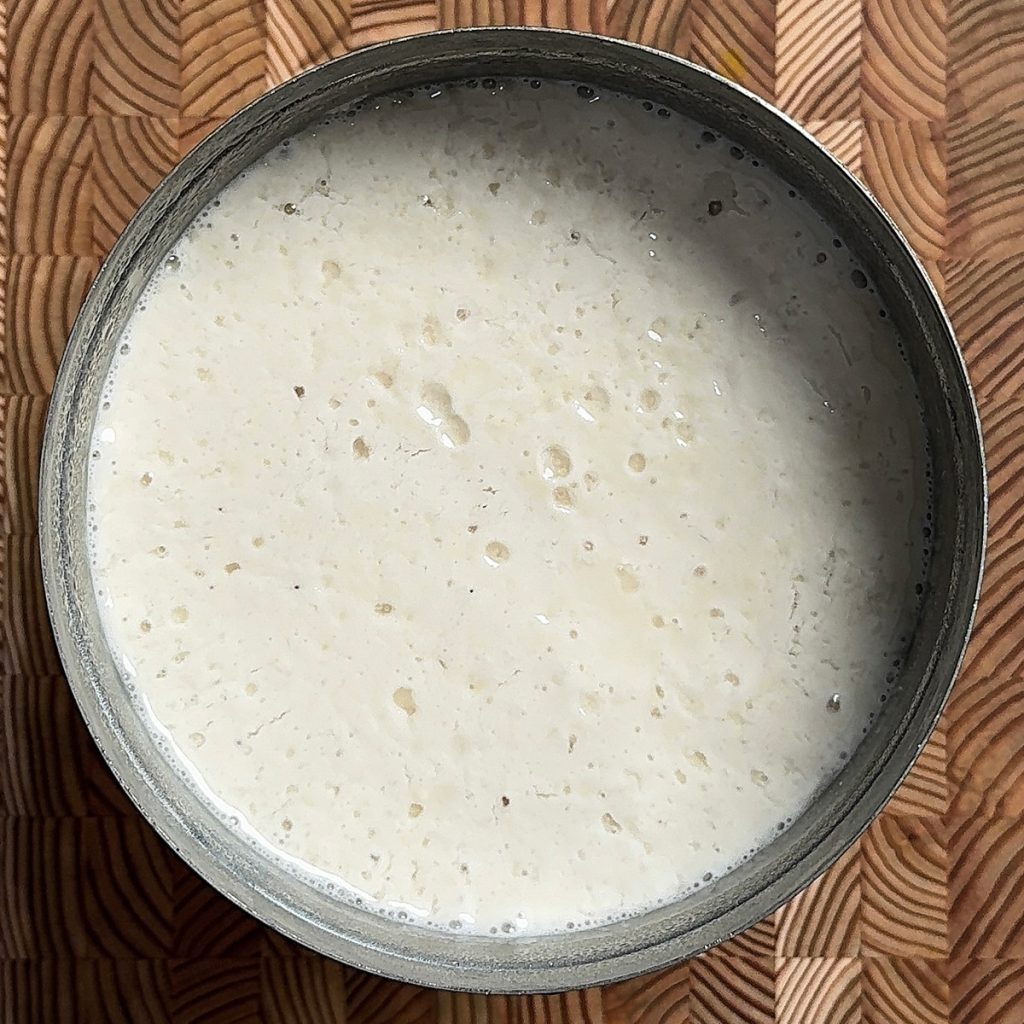 Perfectly fermented authentic Sona Masoori dosa batter in steel bowl showing bubbles and smooth texture