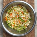 Finished cabbage carrot green pepper salad base with crisp white cabbage, orange carrots, and green peppers mixed together