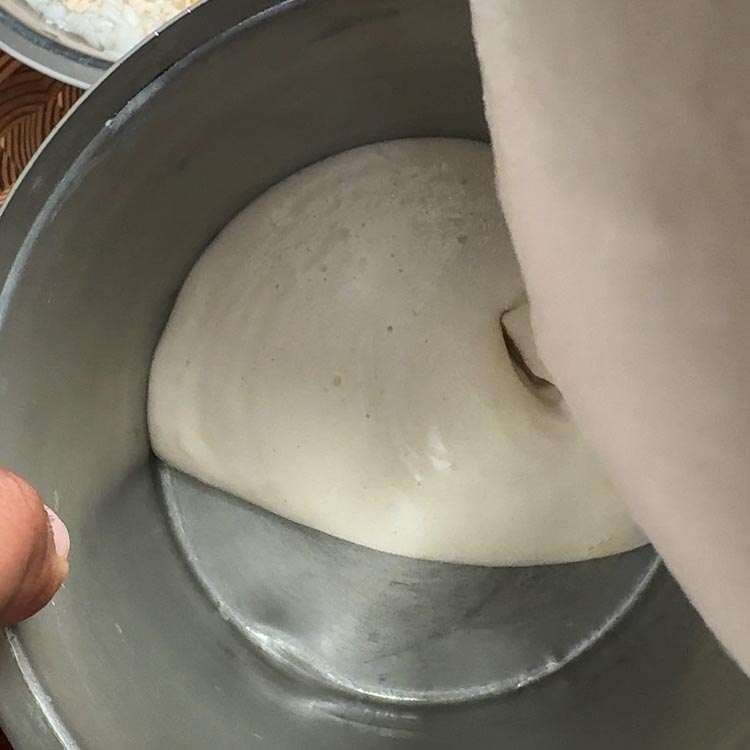 Grinding soaked ingredients into smooth dosa batter using Indian mixi blender