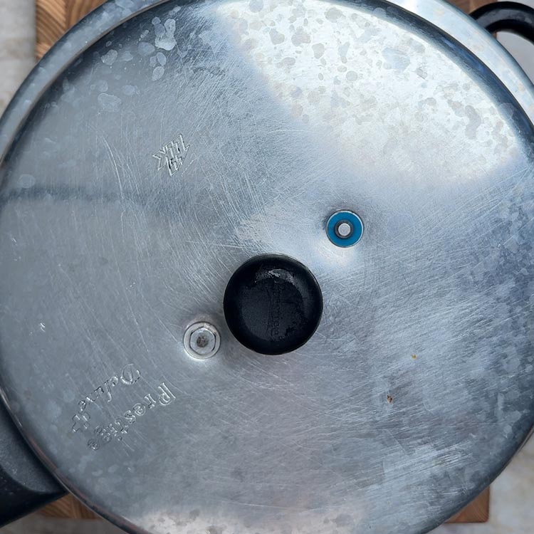 aluminum pressure cooker lid on stove cooking the high protien rice