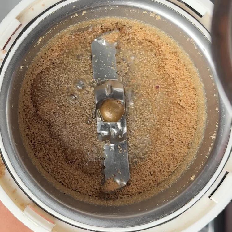 Smooth tan poppy seed paste freshly ground in spice grinder bowl