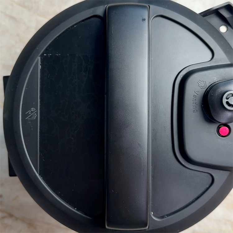 black pressure cooker closed lid top view