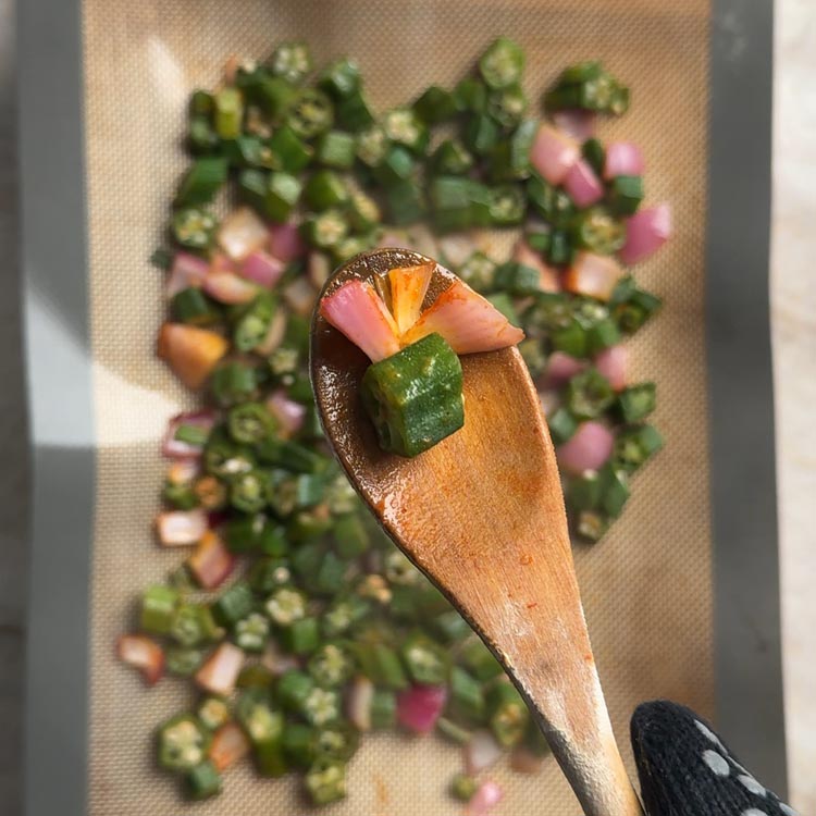 Okra and onions at 15 minute mark showing early browning halfway through baking