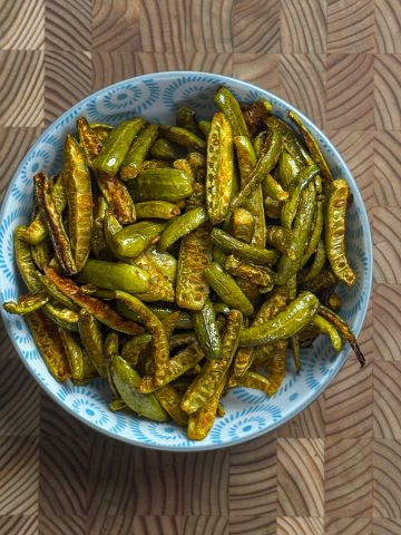 Crispy oven roasted dondakaya fry served in a blue patterned bowl