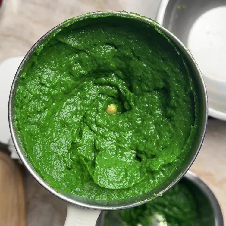 Vibrant bright green spinach and broccoli puree in blender jar after blending
