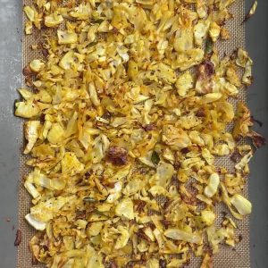 Indian cabbage fry with caramelized edges and whole spices on a sheet pan