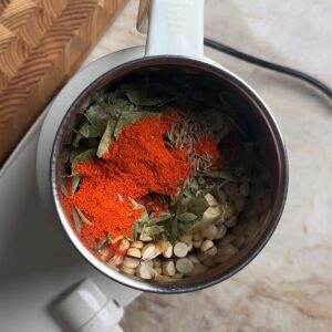 roasted peanuts, chana dal, curry leaves, chili powder, cumin seeds, and garlic in a mixer grinder jar