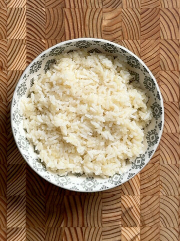 Overhead view of cooked rice and riced cauliflower blend in a patterned bowl